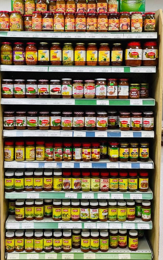 Shelves filled with pickles, pastes and condiments